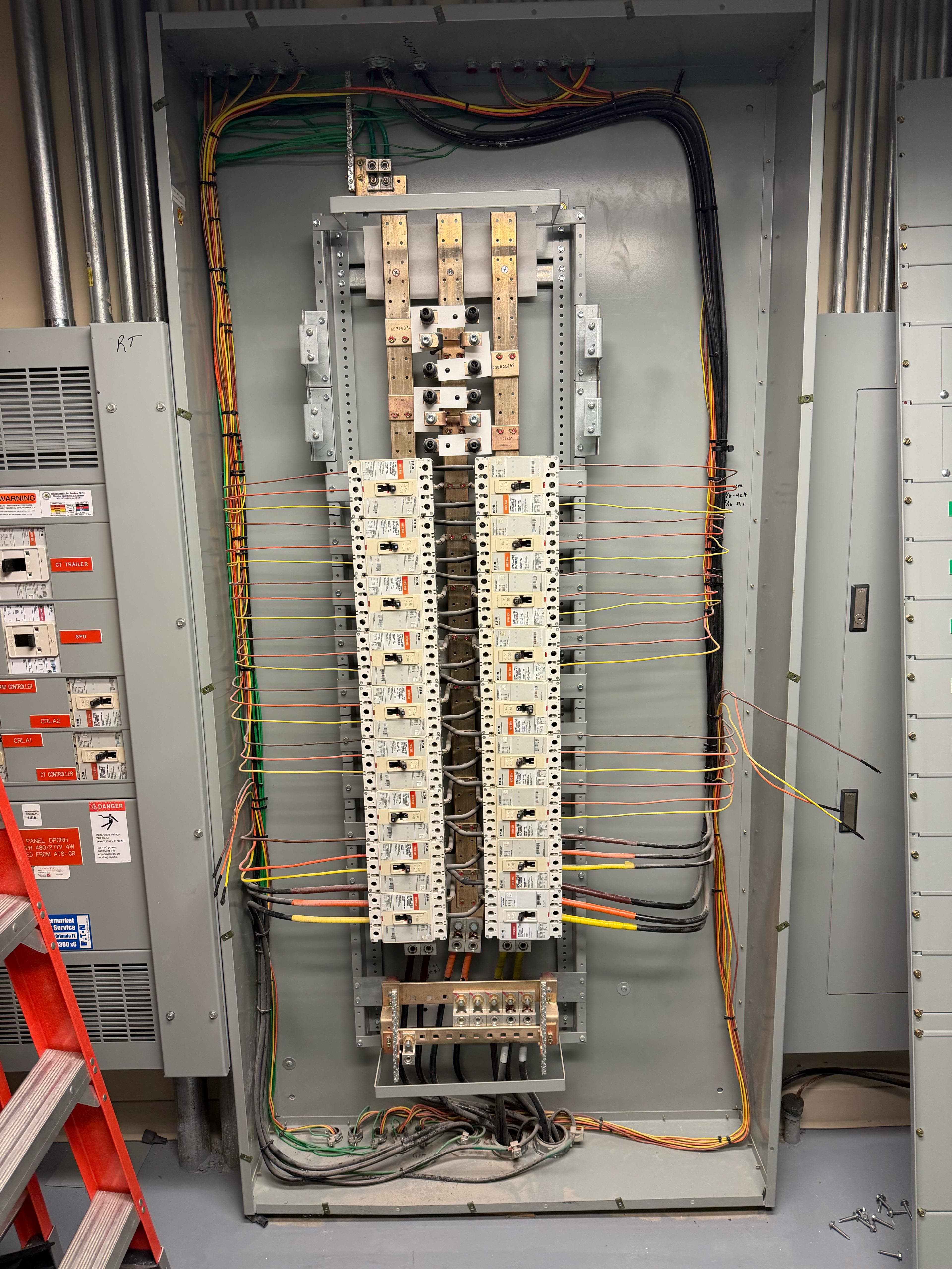 Open distribution panel with labeled breakers